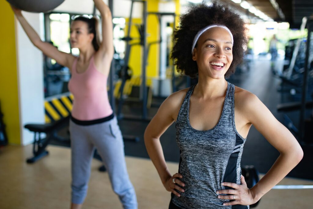 Beautiful women working out in gym together